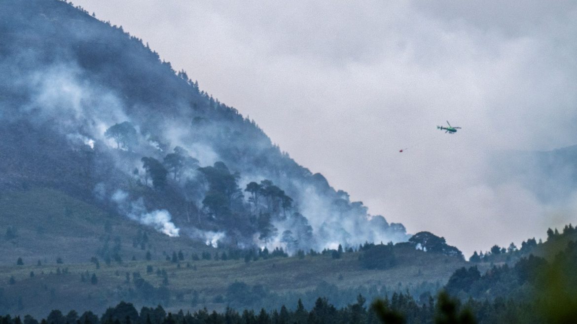 Helicopters join efforts to waterbomb wildfire within UK's largest national park